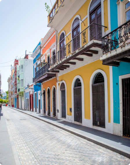 A street with colorful buildings and balconies.