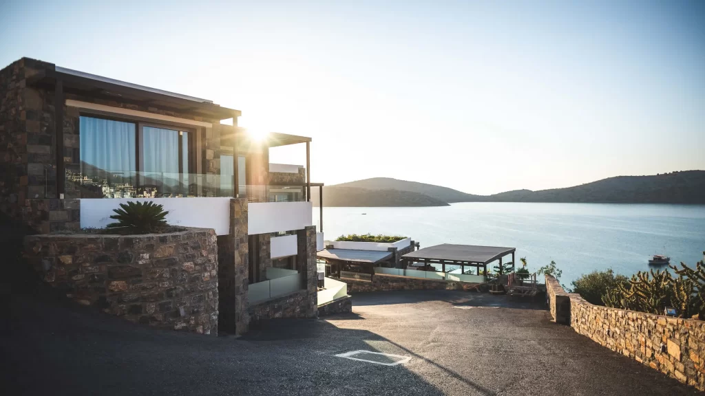 A house on a hill overlooking the sea.