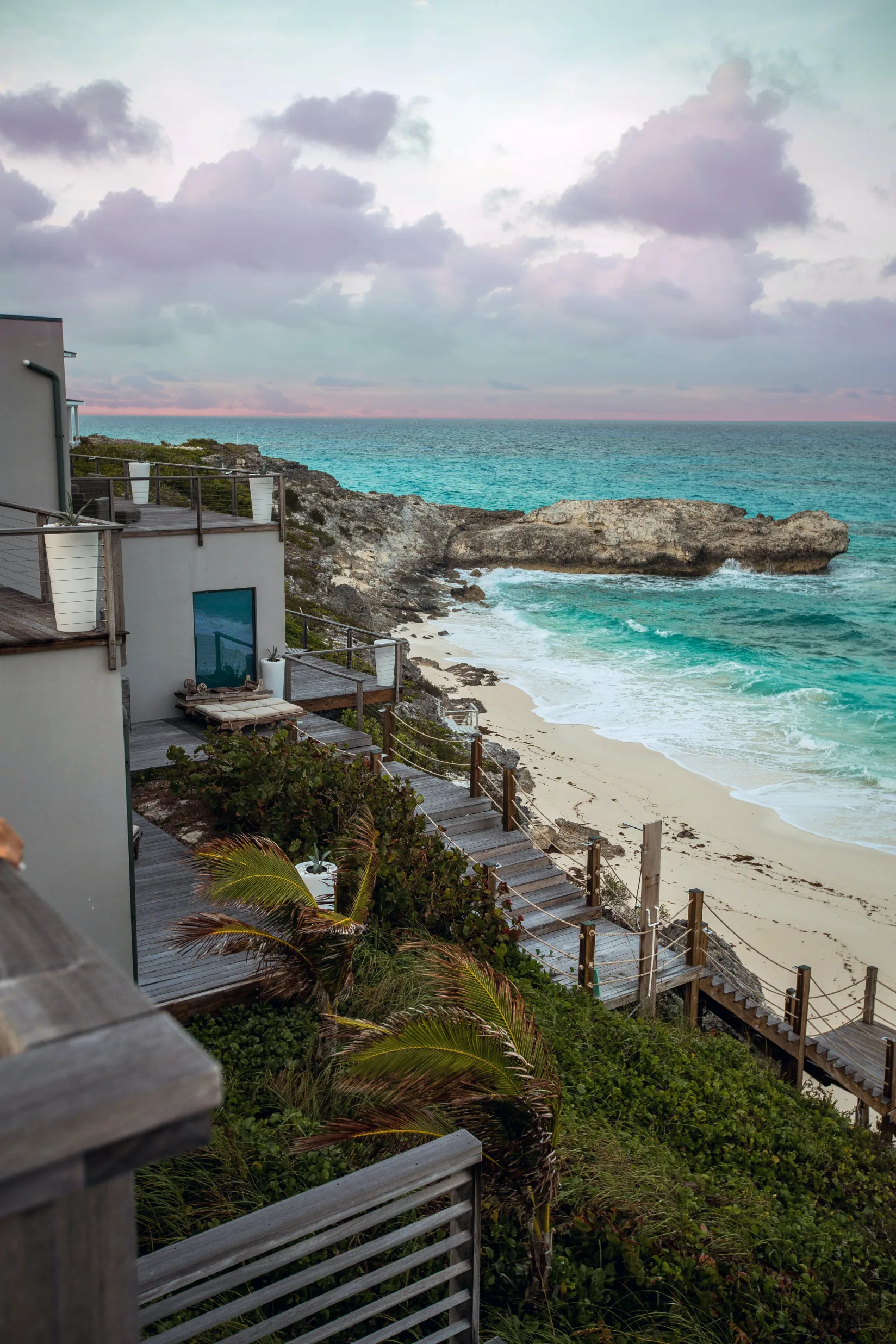 A house on a beach with a view of the ocean.