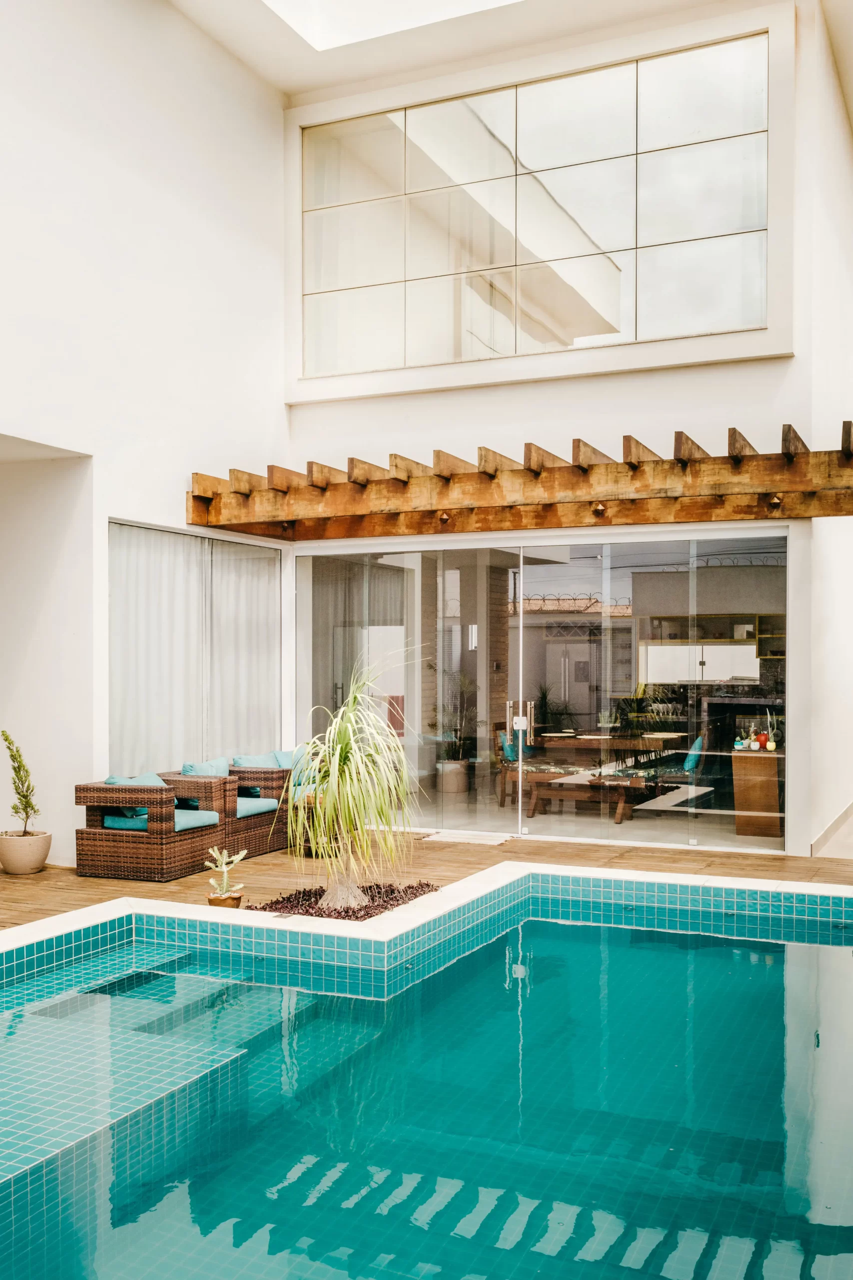 A swimming pool in the backyard of a house.