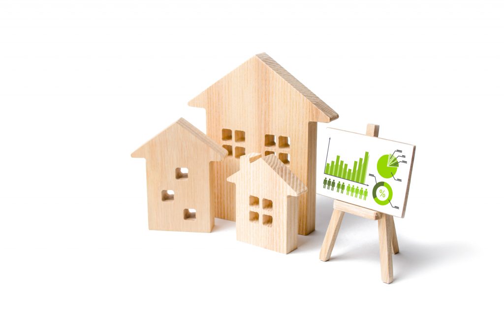 A wooden model of a house with a graph on it.